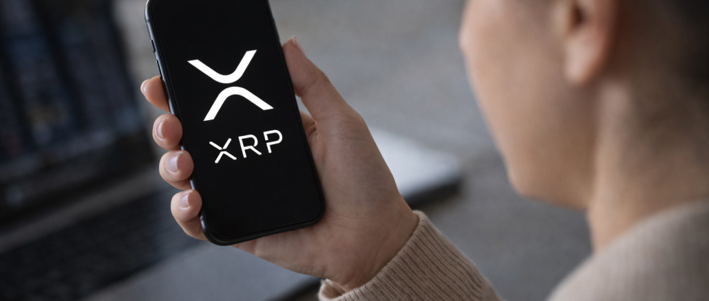 Person holding a smartphone displaying the XRP cryptocurrency logo while checking digital asset markets.